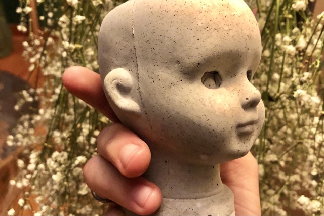 cement cast from mold of porcelain doll head